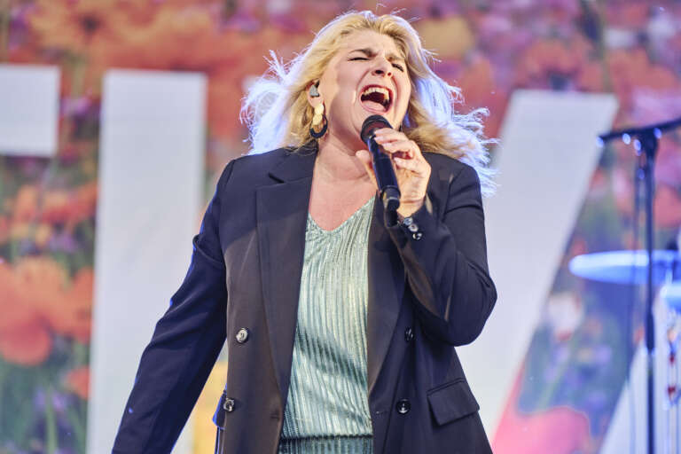 A singer delivers a powerful performance on stage during the festival.