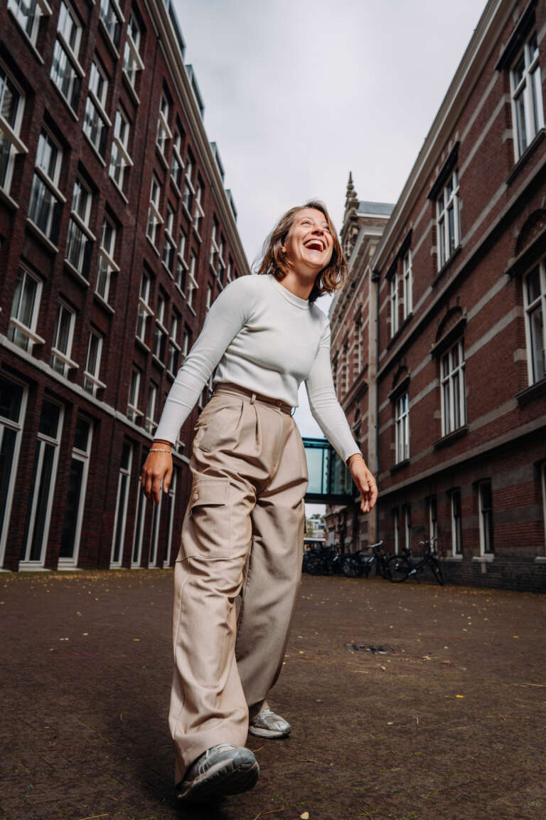 Dynamic portrait of a OVAL employee walking in the city.