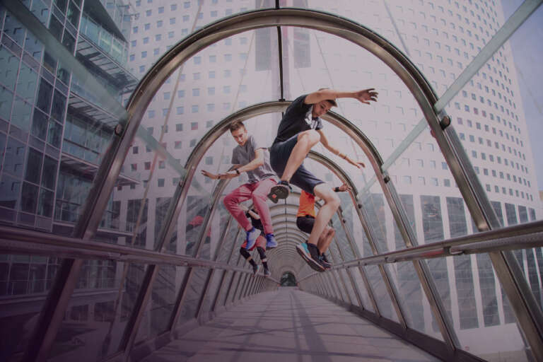 Young people performing an acrobatic figure in an urban tunnel, embodying the energy of street activations