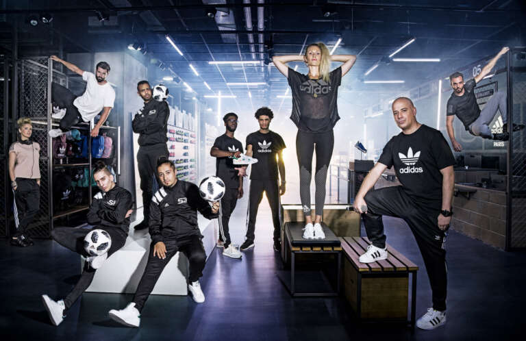 Adidas brand ambassadors posing in a bold urban setting inside the store.
